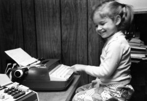 Five year old me typing next to an adding machine didn't know she would become an engineer and fiction writer.